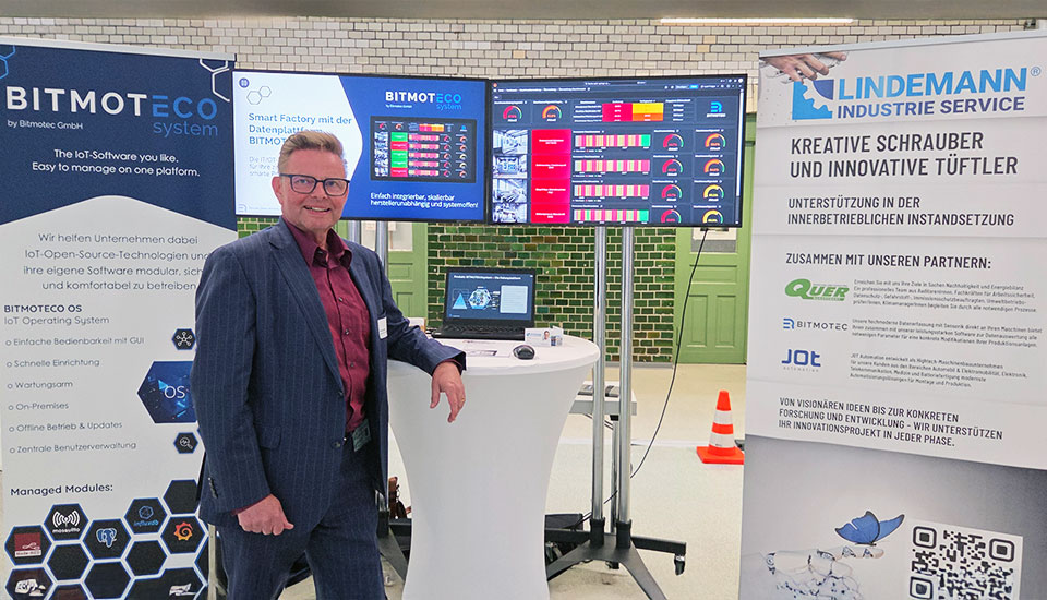 Messestand von Bitmotec und Lindemann Industrie Service auf der 5G-Fachtagung mit Monitoren und Infobannern.