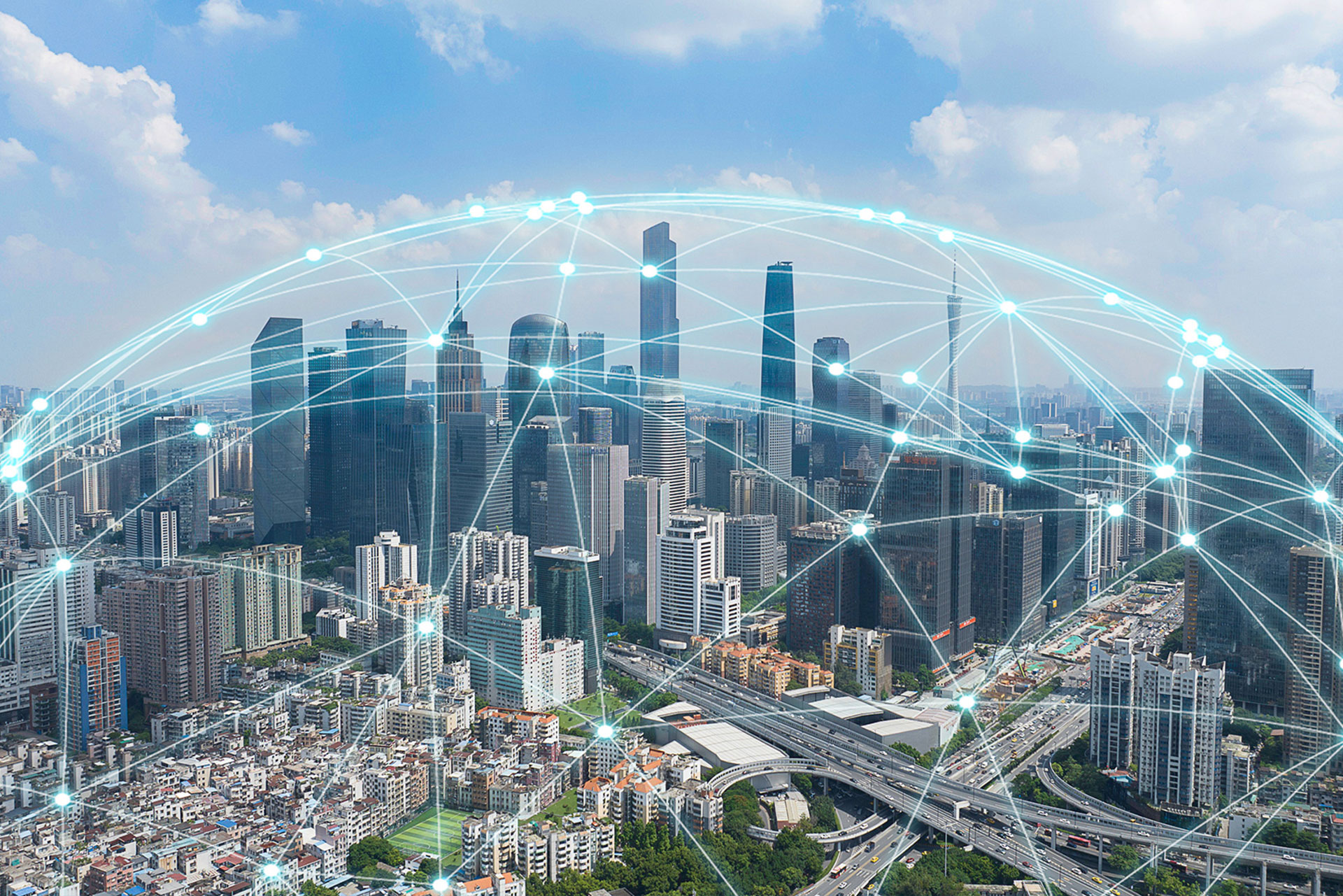 Luftaufnahme einer modernen Großstadt mit Hochhäusern und Straßennetz, überlagert von einer grafischen Darstellung globaler Netzwerkverbindungen, symbolisierend digitale Vernetzung und Kommunikation.